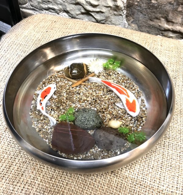 2 Koi handprinted in a bowl with sand and rocks and plants